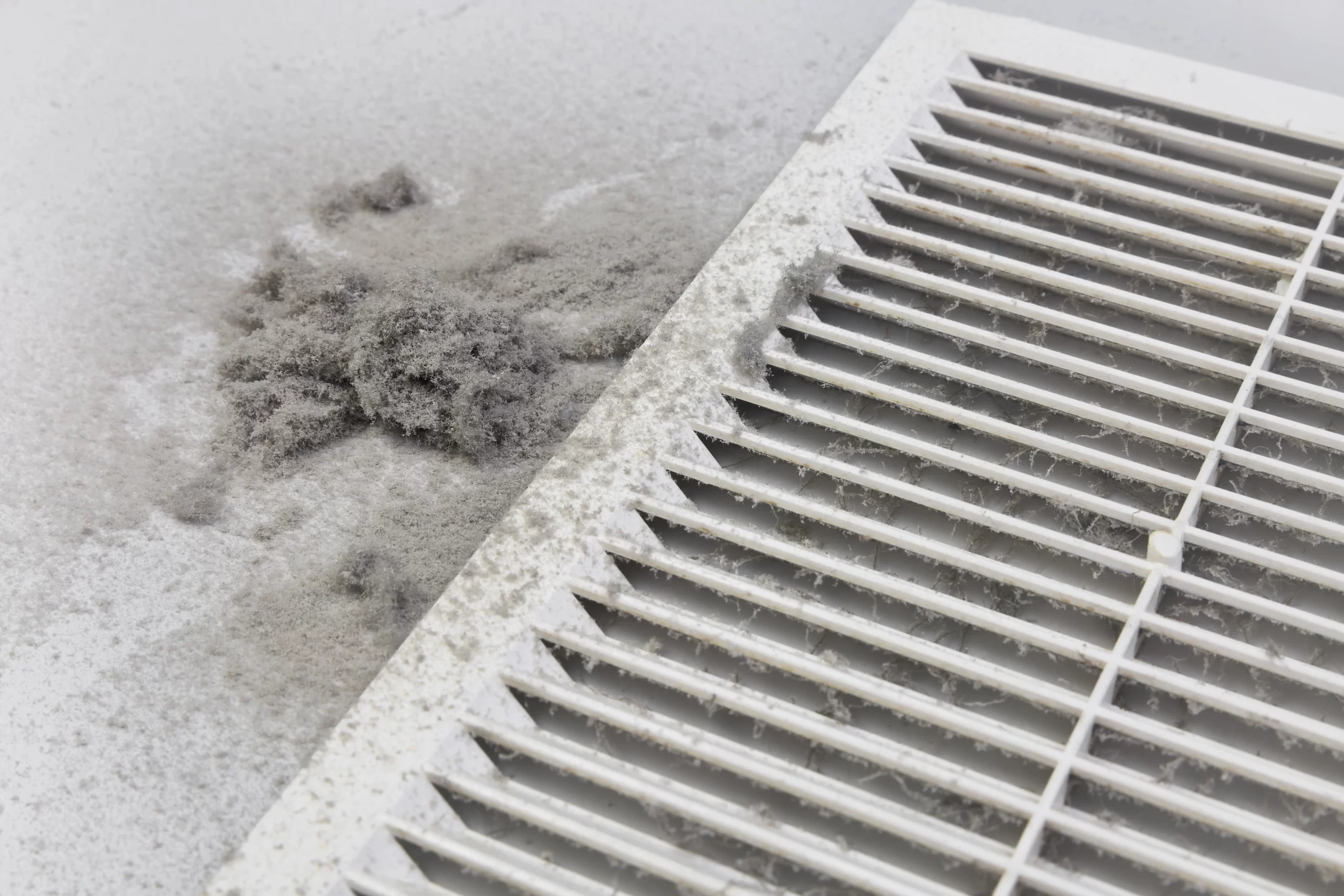 Dust cloud rising from HVAC vent indicating dirty ductwork